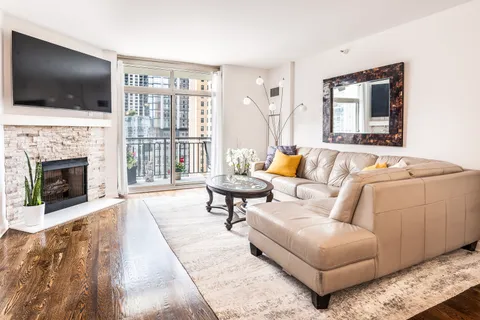 a living room with fireplace furniture and a flat screen tv