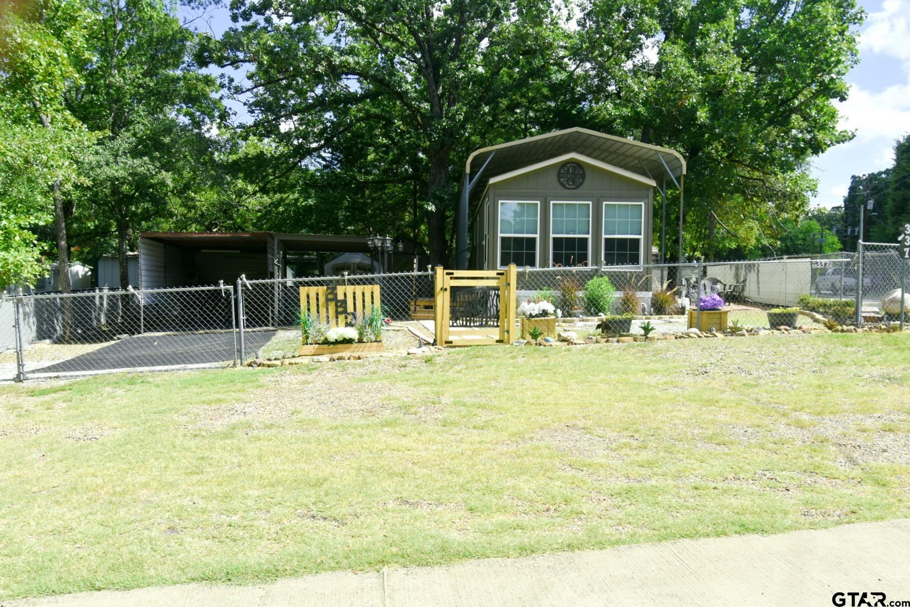 a front view of house with yard having swimming pool