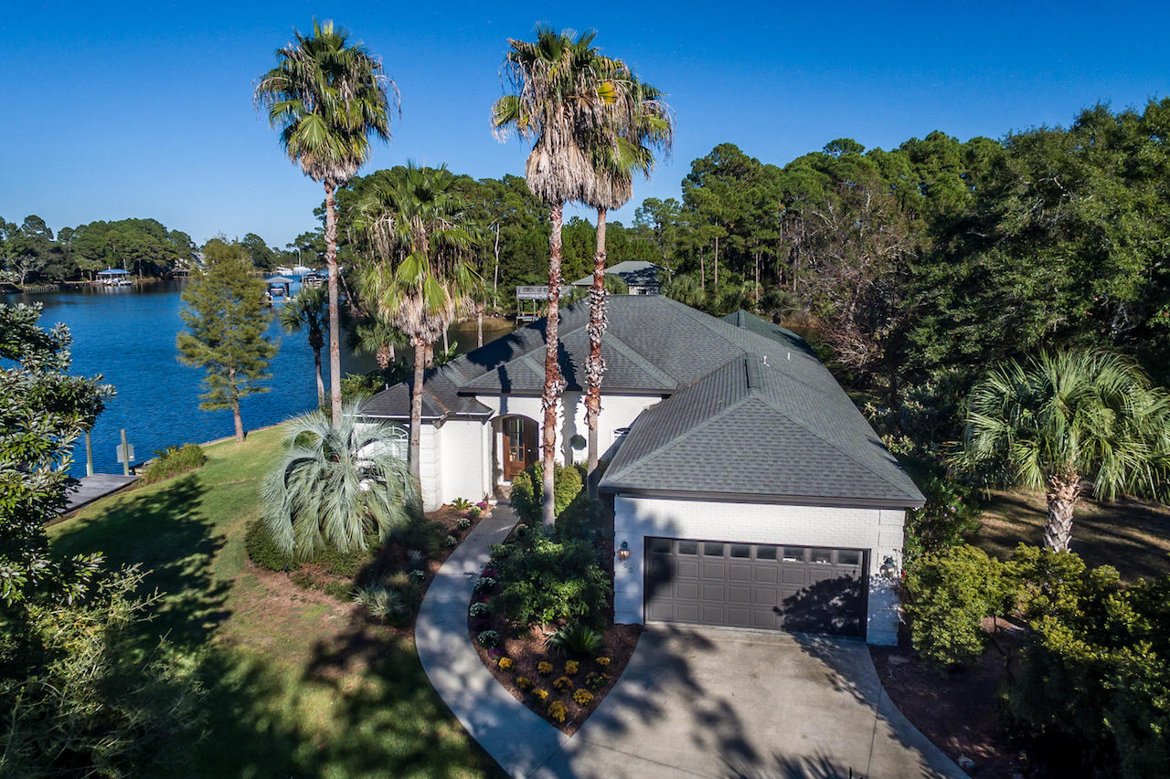 300 West Harborview Road Santa Rosa Beach, FL 32459 - Photo 5 of 48 a view of a house with a yard and garden