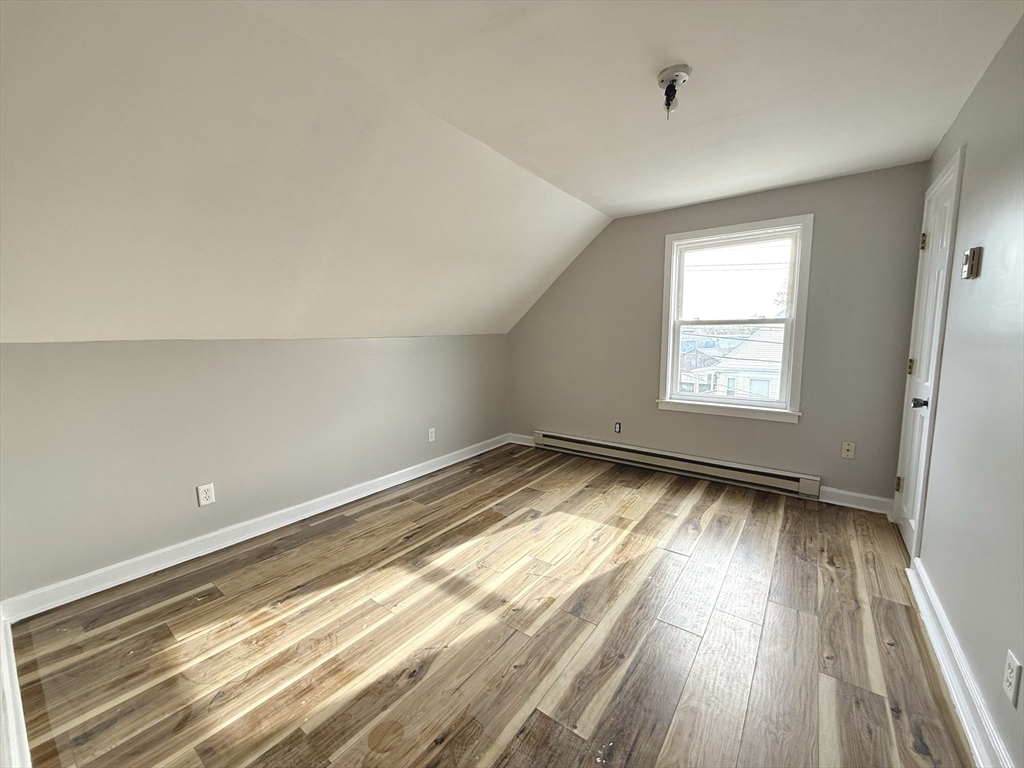 13 Brooks Avenue, Unit 2 Quincy, MA 02169 - Photo 11 of 15 wooden floor in an empty room with a window