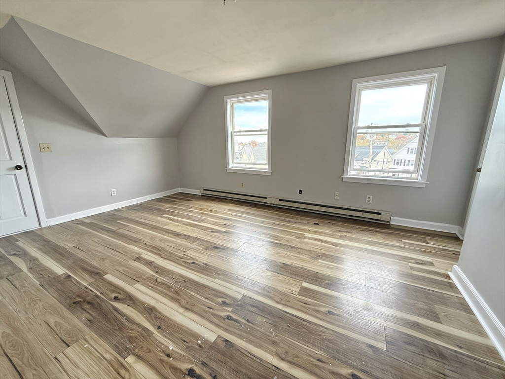 13 Brooks Avenue, Unit 2 Quincy, MA 02169 - Photo 13 of 15 a view of empty room with wooden floor and fan