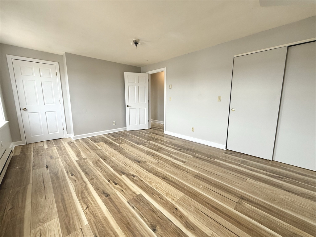 13 Brooks Avenue, Unit 2 Quincy, MA 02169 - Photo 15 of 15 a view of a room with wooden floor
