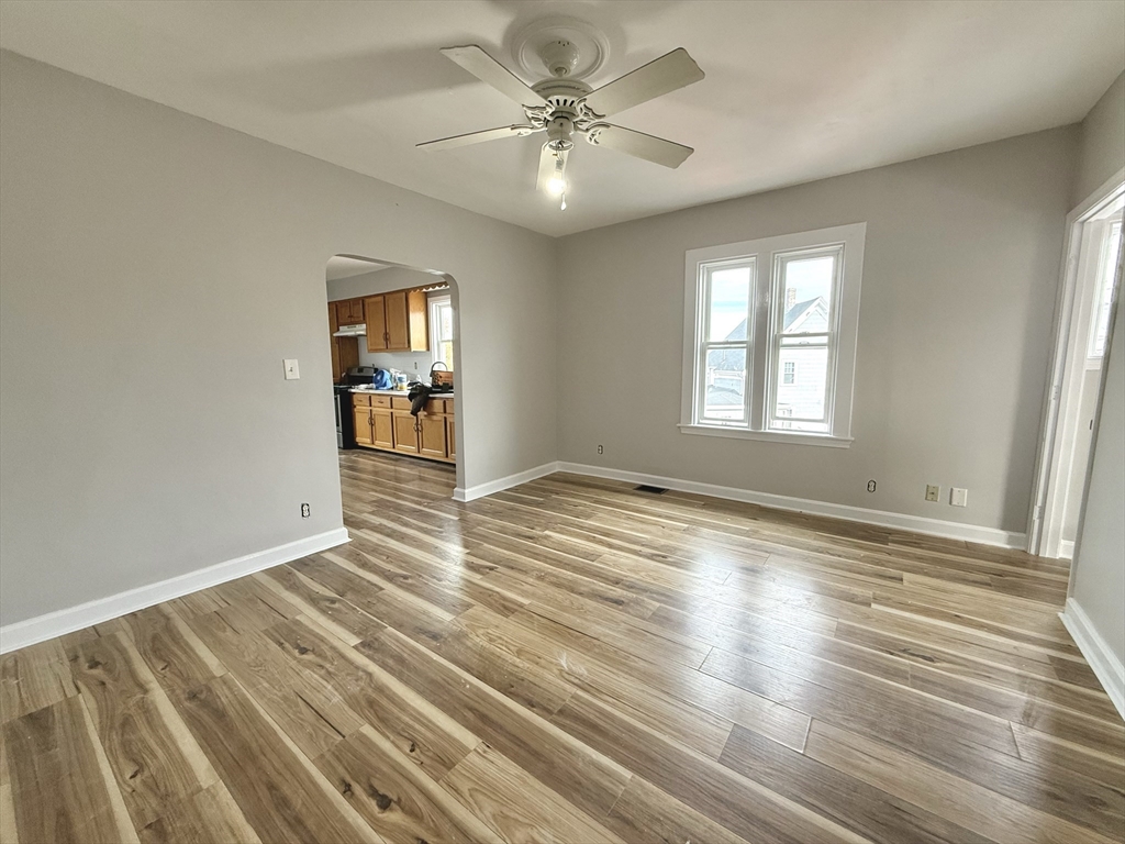 13 Brooks Avenue, Unit 2 Quincy, MA 02169 - Photo 2 of 15 an empty room with wooden floor and windows