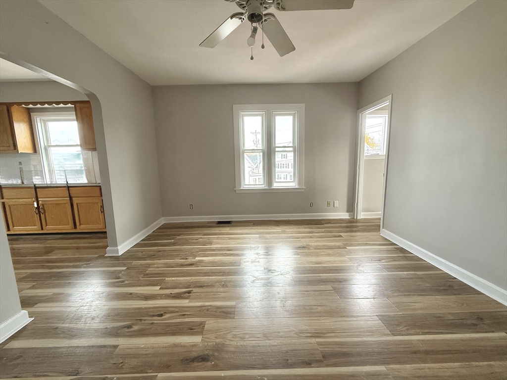 13 Brooks Avenue, Unit 2 Quincy, MA 02169 - Photo 4 of 15 a view of an empty room with window and wooden floor