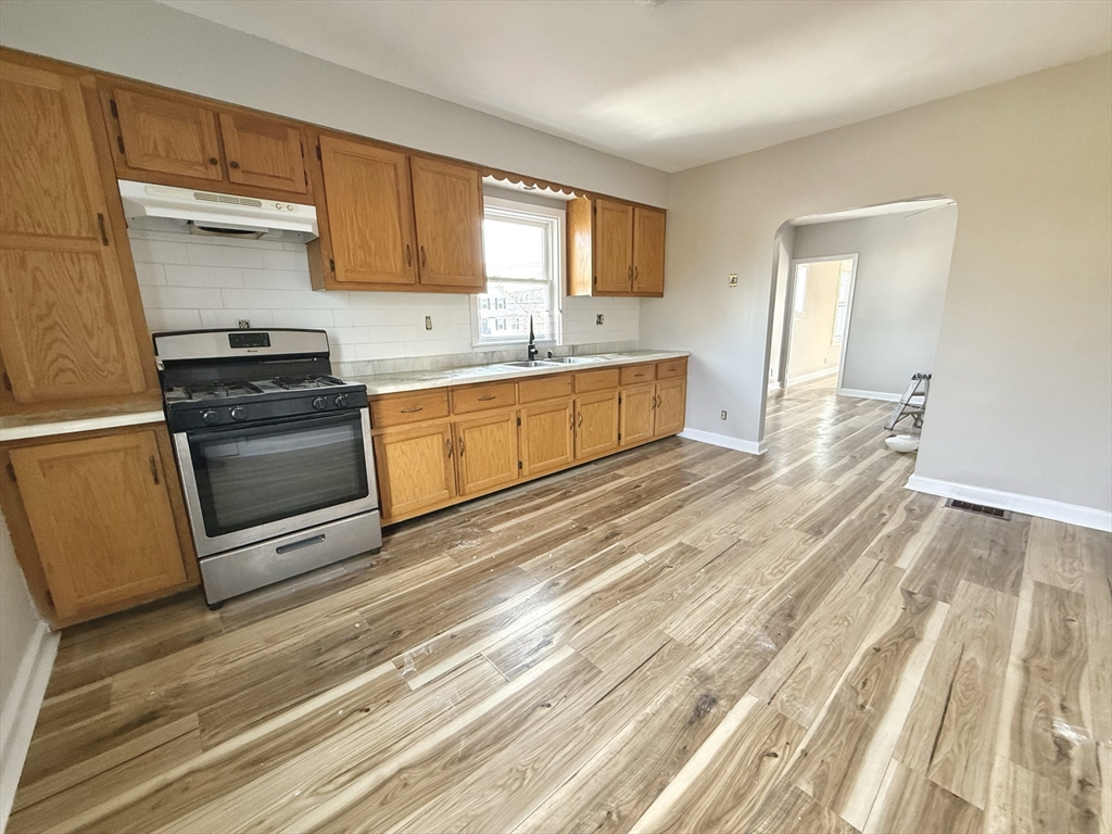 13 Brooks Avenue, Unit 2 Quincy, MA 02169 - Photo 5 of 15 a kitchen with stainless steel appliances granite countertop a stove a sink and a refrigerator