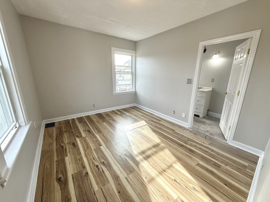 13 Brooks Avenue, Unit 2 Quincy, MA 02169 - Photo 8 of 15 a view of wooden floor in a room