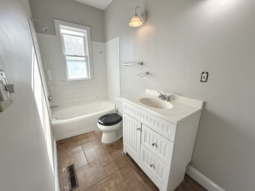 13 Brooks Avenue, Unit 2 Quincy, MA 02169 - Photo 10 of 15 a bathroom with a sink a toilet and a bathtub