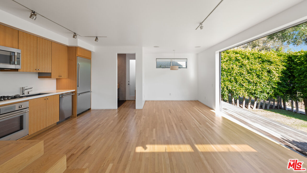705 Sunset Avenue, Unit FRONT Venice, CA 90291 - Photo 1 of 17 a view of a kitchen with wooden floor and a window
