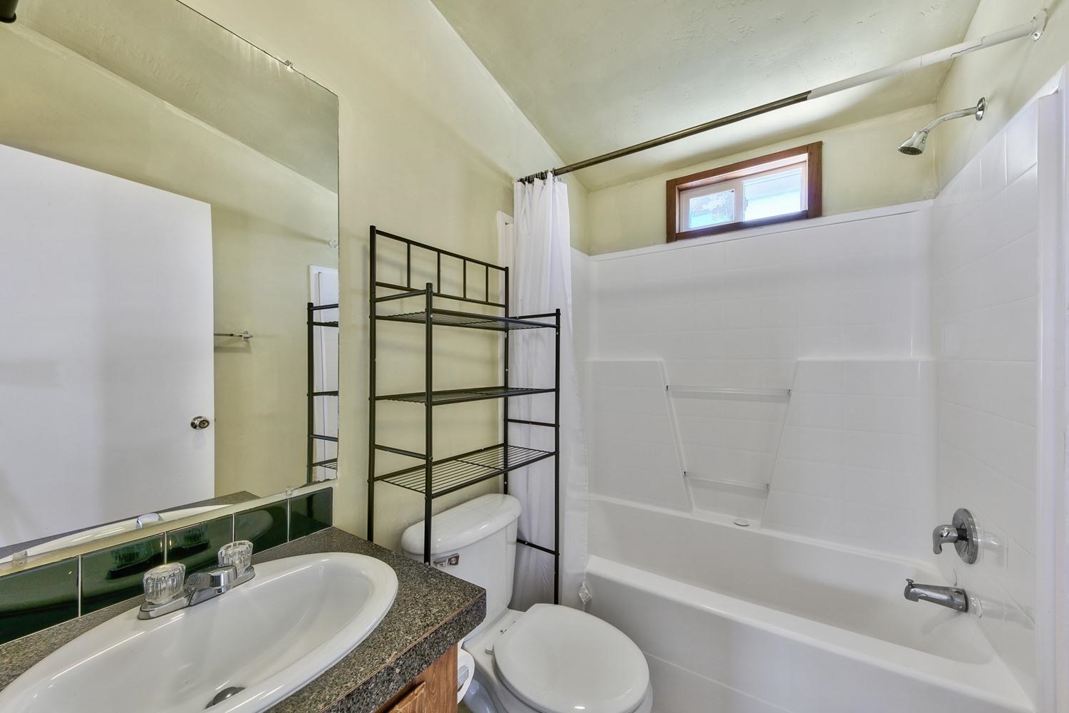11070 Brockway Road, Unit 70 Truckee, CA 96161 - Photo 12 of 16 a bathroom with a granite countertop sink toilet a mirror and shower