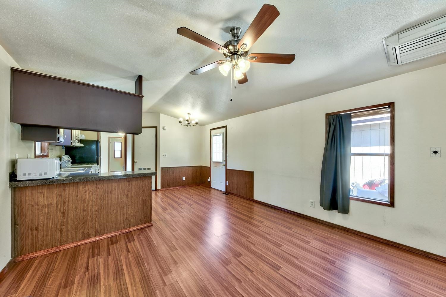 11070 Brockway Road, Unit 70 Truckee, CA 96161 - Photo 8 of 16 a living room with wooden floor and a ceiling fan