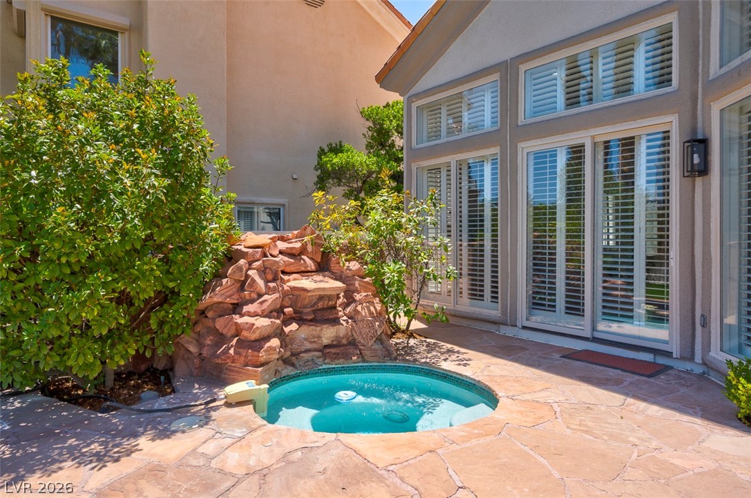 8848 Rainbow Ridge Drive Las Vegas, NV 89117 - Photo 39 of 43 An inviting private spa with a rock waterfall feature enhances this patio's appeal.