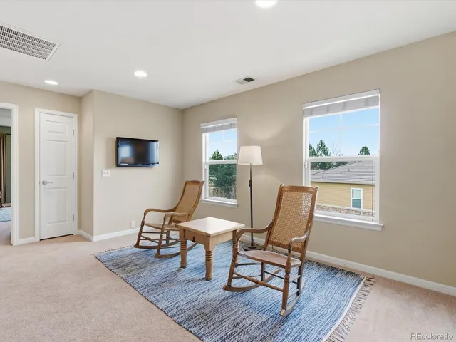 an aerial view of residential houses with outdoor space and trees