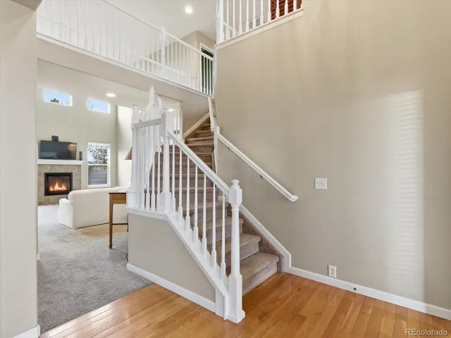 a living room with furniture a pool table and a fireplace