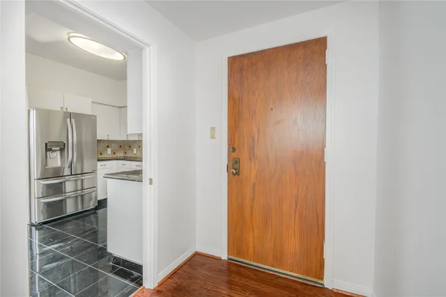 a view of an empty room window and wooden floor