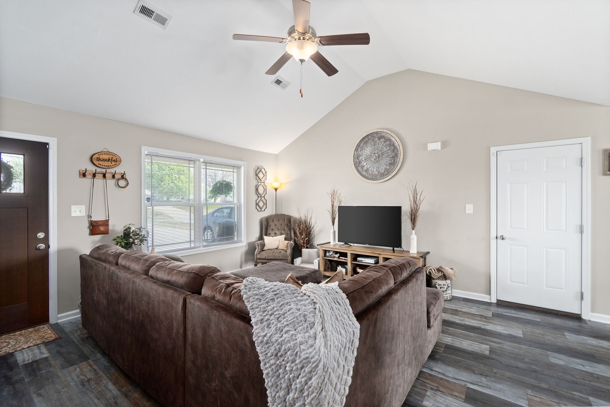 905 Hugh Hunter Road Oak Grove, KY 42262 - Photo 7 of 33 a living room with furniture a fireplace and a large window