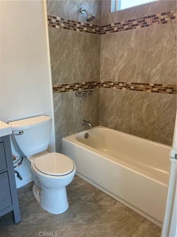 a bathroom with a toilet and a bathtub