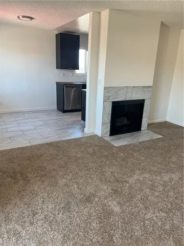 a living room with a fireplace and a flat screen tv