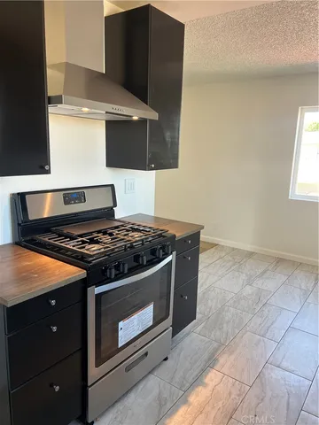 a stove top oven sitting inside of a kitchen