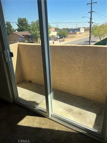 a view of a glass door with a floor to ceiling window
