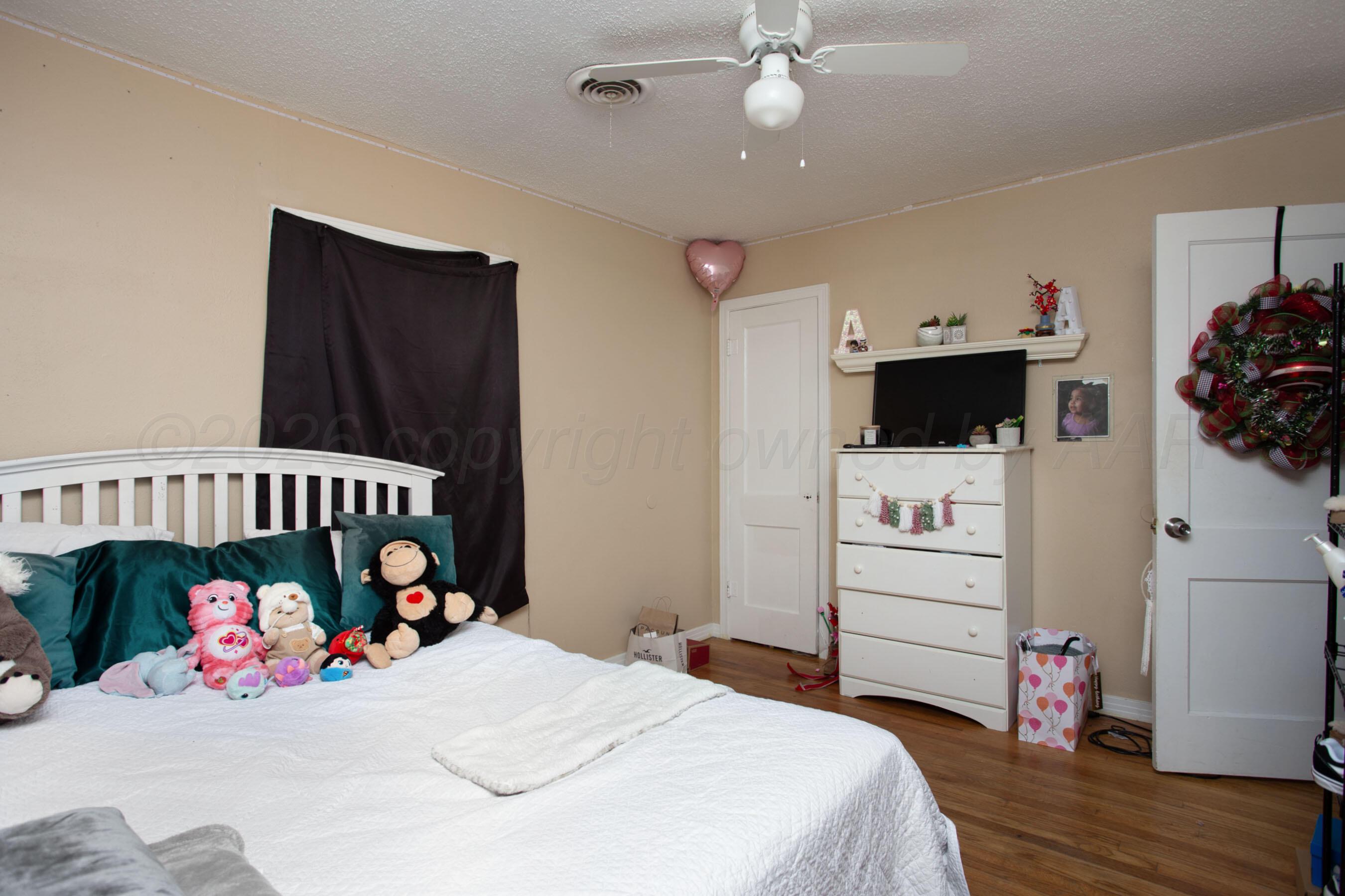 4003 South Van Buren Street Amarillo, TX 79110 - Photo 11 of 25 a bedroom with a bed and a tv