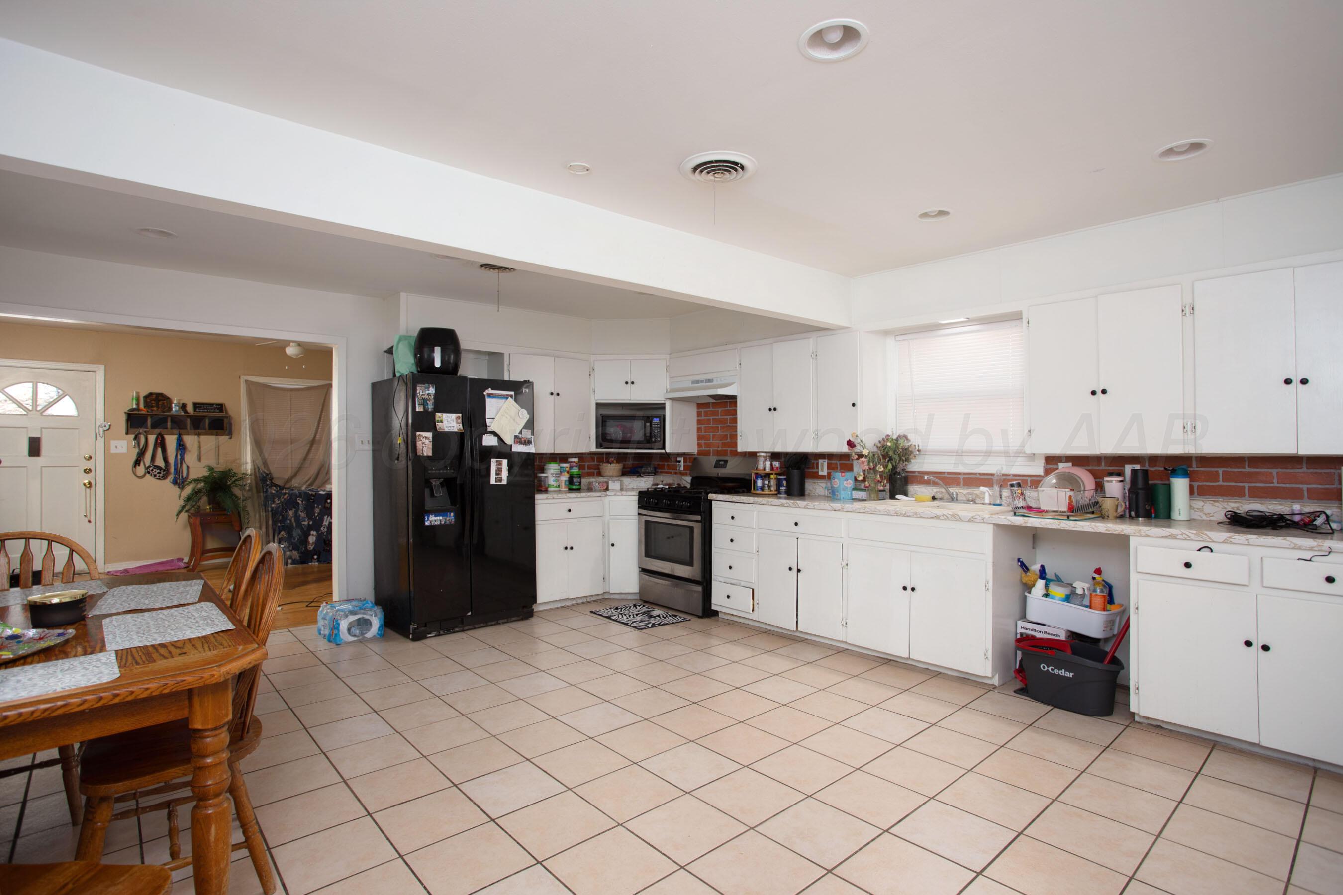 4003 South Van Buren Street Amarillo, TX 79110 - Photo 18 of 25 a kitchen with a sink window and stainless steel appliances