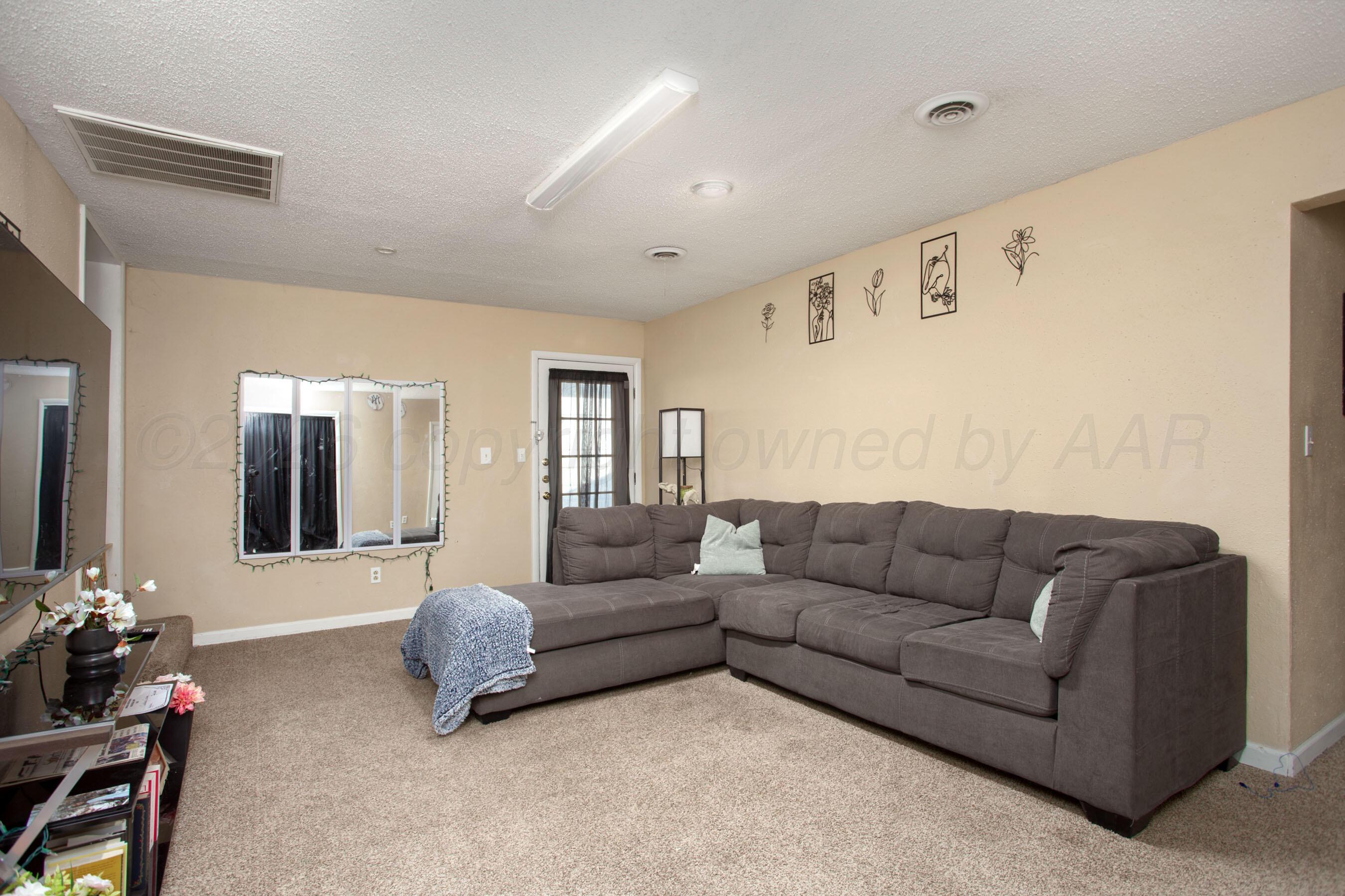 4003 South Van Buren Street Amarillo, TX 79110 - Photo 5 of 25 a living room with furniture and wooden floor