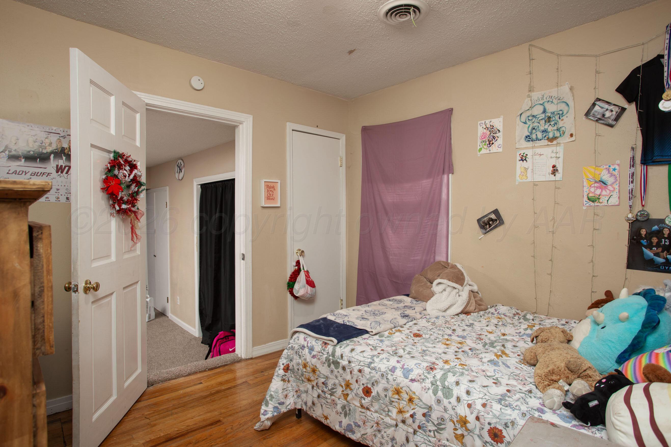4003 South Van Buren Street Amarillo, TX 79110 - Photo 9 of 25 a bedroom with a bed and a window