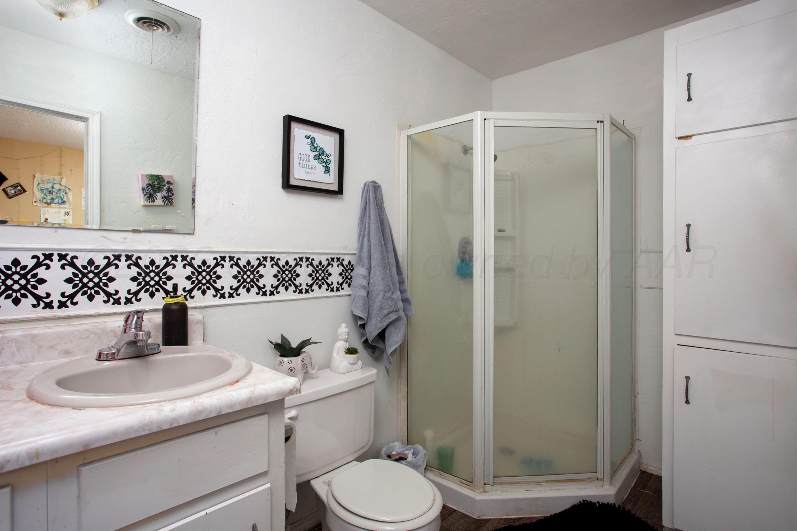 4003 South Van Buren Street Amarillo, TX 79110 - Photo 10 of 25 a bathroom with a sink toilet and shower