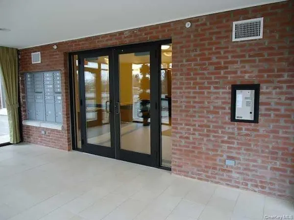 a view of a brick house with a large windows