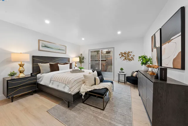 a spacious bedroom with a bed and a couch