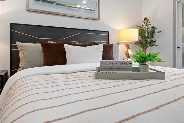 a bedroom with a bed and a potted plant