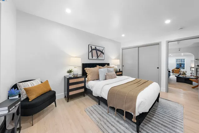 a spacious bedroom with a bed and a couch