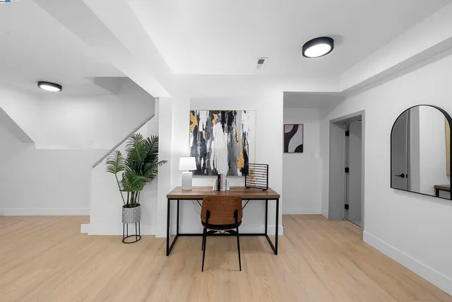 a workspace with furniture window and wooden floor