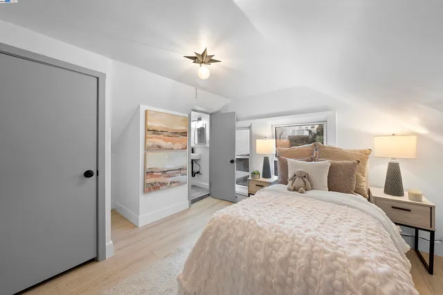 a bedroom with a large bed and a chandelier