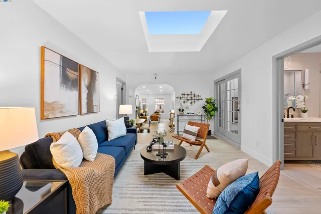 a living room with furniture and a chandelier