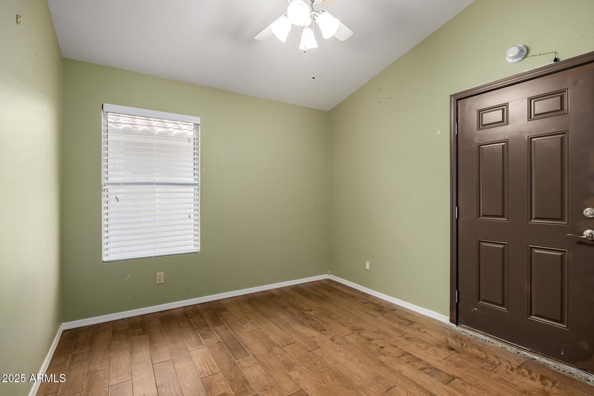 14841 South 46th Place Phoenix, AZ 85044 - Photo 27 of 43 a view of an empty room with wooden floor and a window