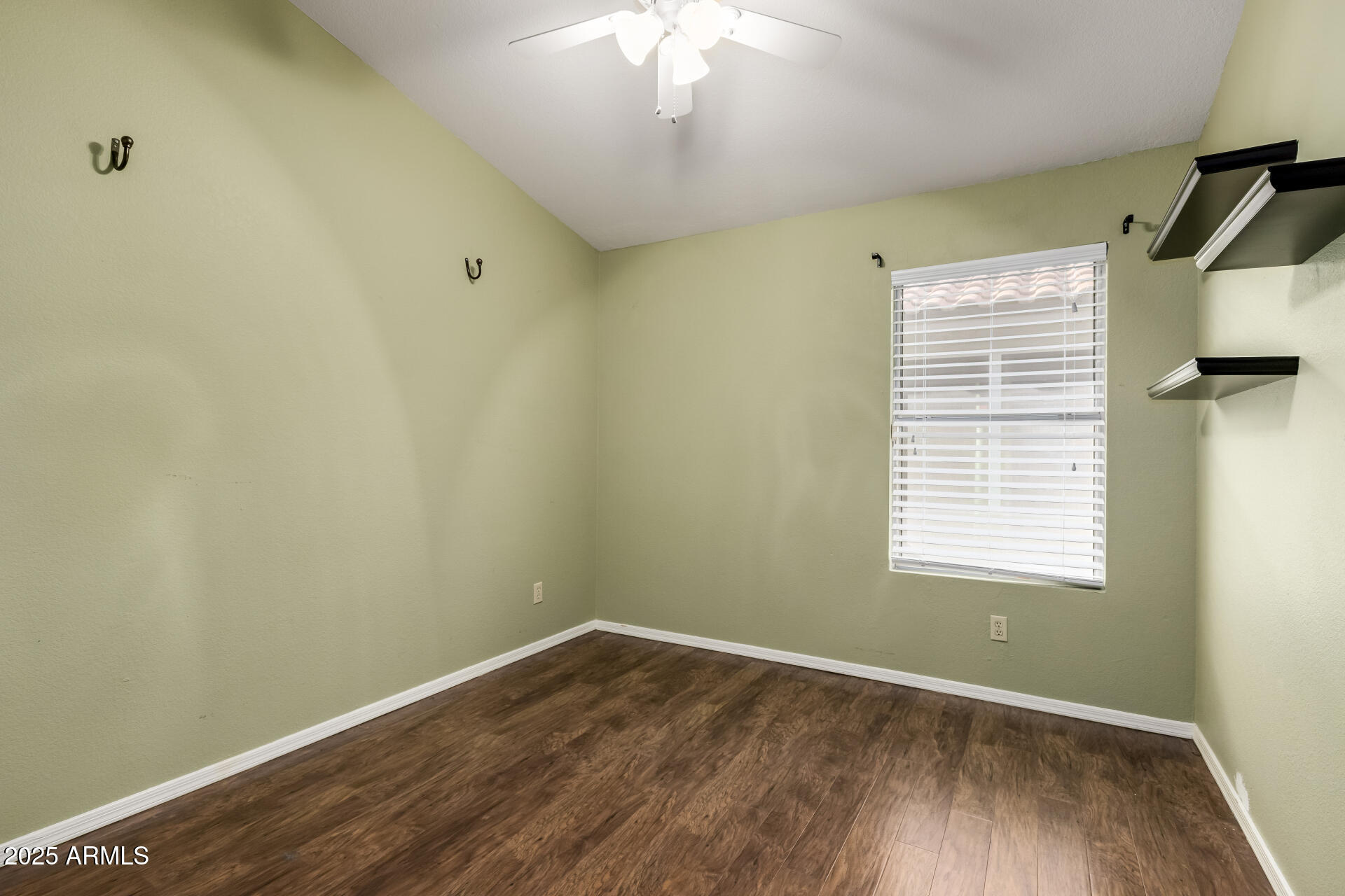 14841 South 46th Place Phoenix, AZ 85044 - Photo 29 of 43 a view of an empty room with wooden floor and a window
