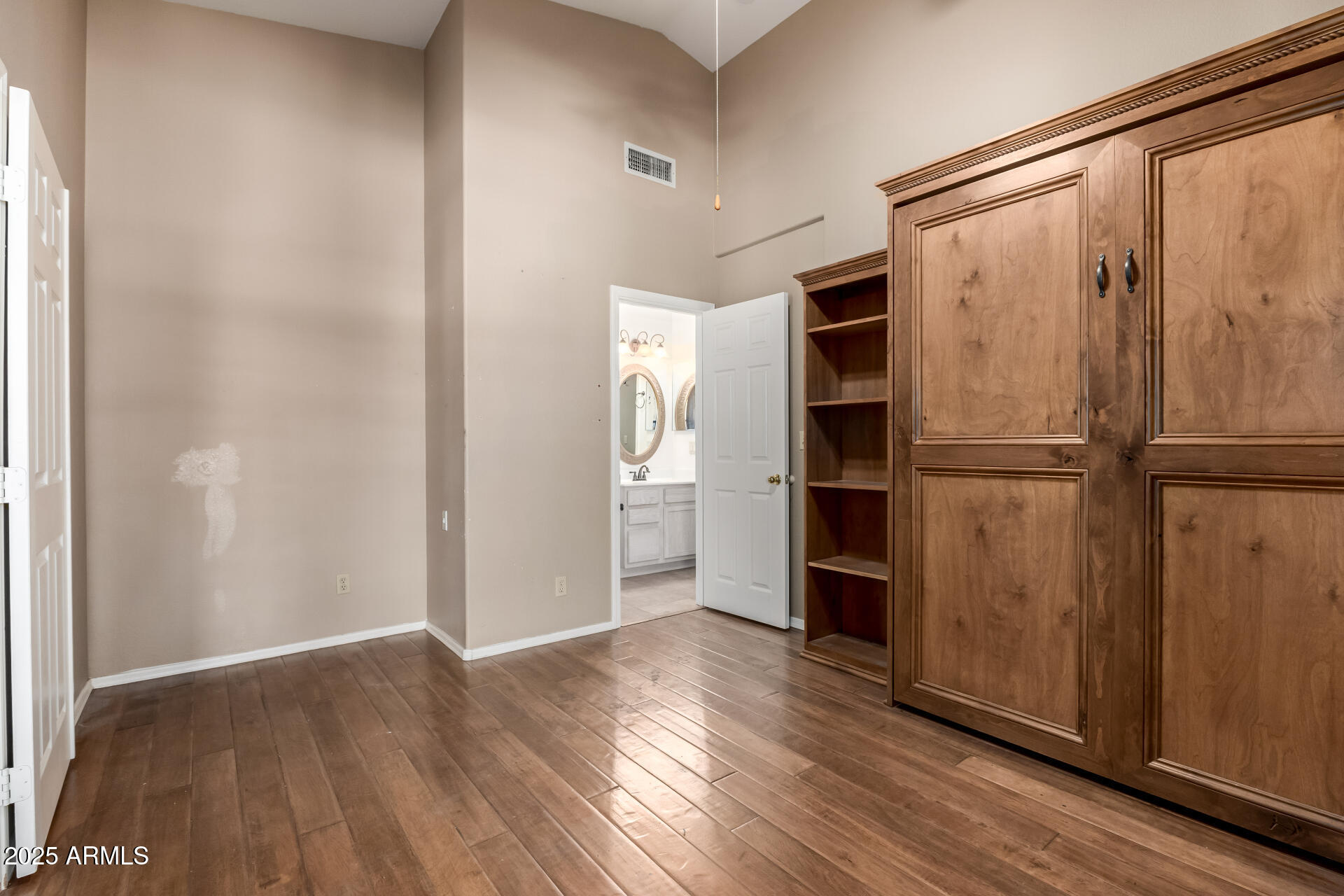 14841 South 46th Place Phoenix, AZ 85044 - Photo 8 of 43 a view of an empty room with a window and wooden floor