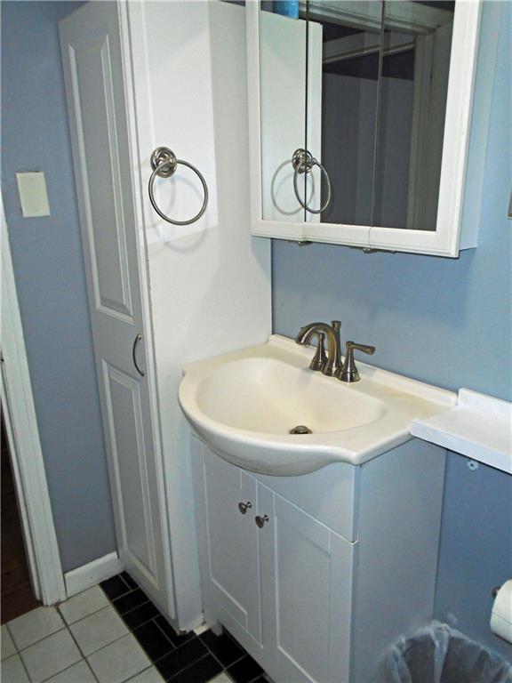 1001 7th Avenue Conway, PA 15027 - Photo 11 of 36 a bathroom with a sink and a mirror