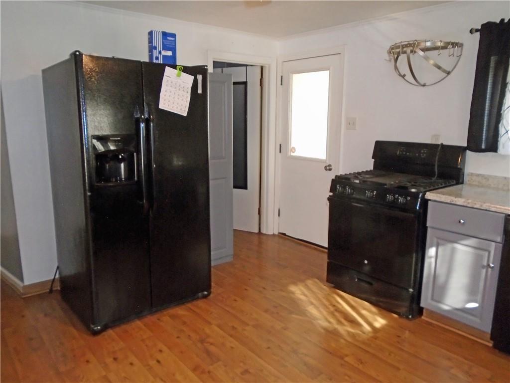 1001 7th Avenue Conway, PA 15027 - Photo 30 of 36 a kitchen with a refrigerator and a stove