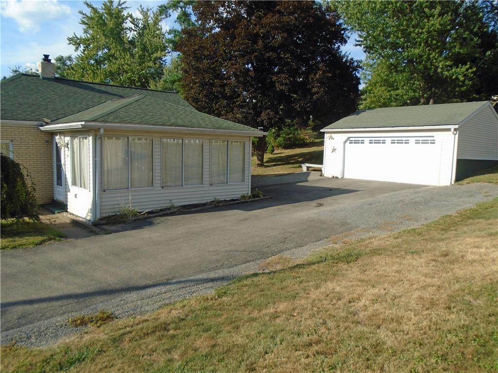 1001 7th Avenue Conway, PA 15027 - Photo 3 of 36 a view of a house with a yard and garage