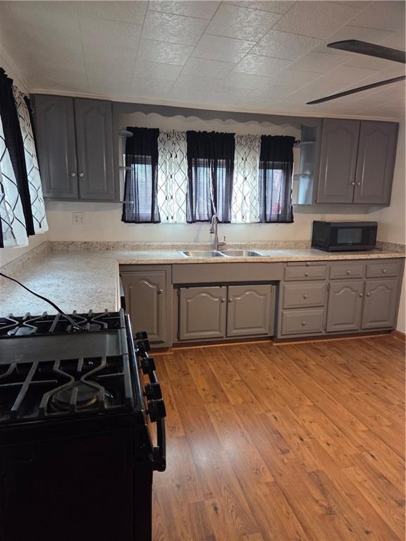 1001 7th Avenue Conway, PA 15027 - Photo 34 of 36 a large kitchen with granite countertop a stove and a sink