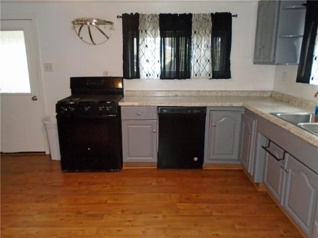 1001 7th Avenue Conway, PA 15027 - Photo 4 of 36 a kitchen with stainless steel appliances granite countertop a refrigerator and a stove