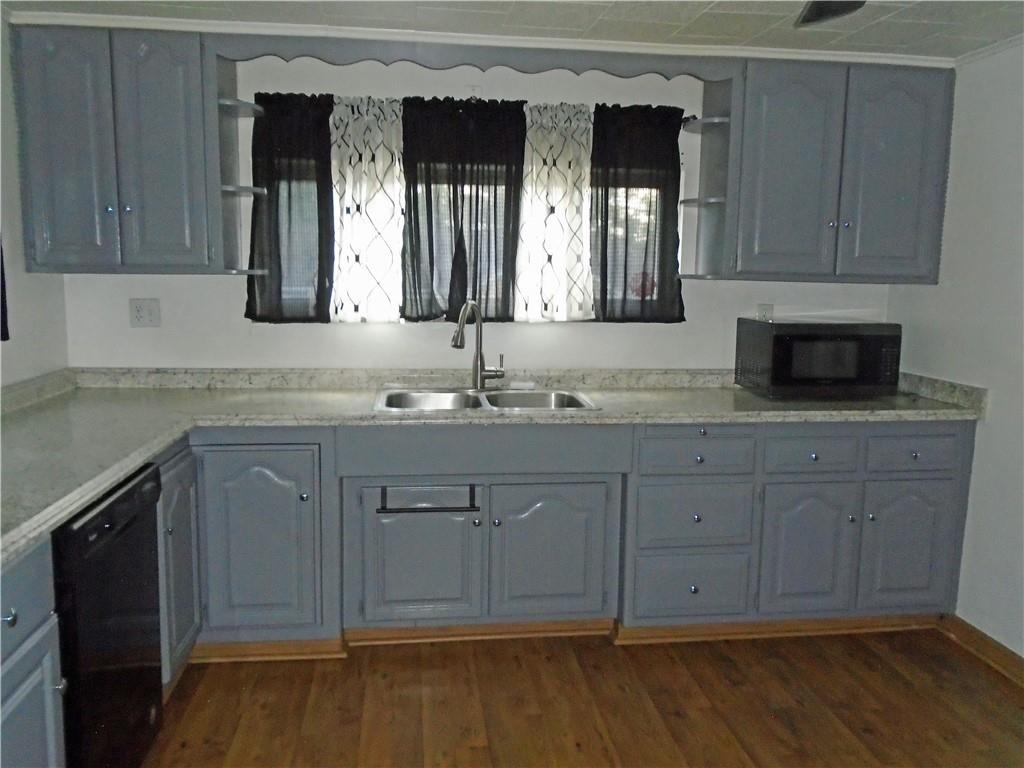 1001 7th Avenue Conway, PA 15027 - Photo 7 of 36 a bathroom with a granite countertop sink vanity and mirror