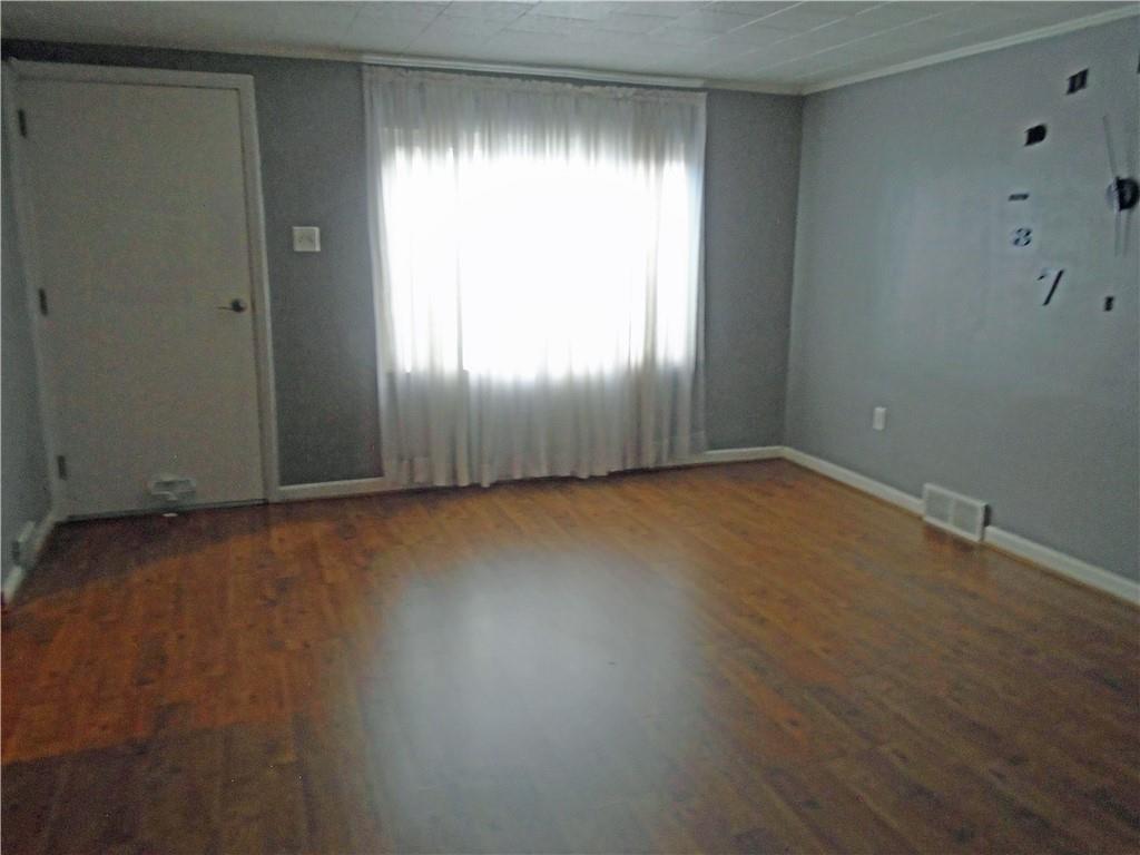 1001 7th Avenue Conway, PA 15027 - Photo 9 of 36 an empty room with wooden floor and windows