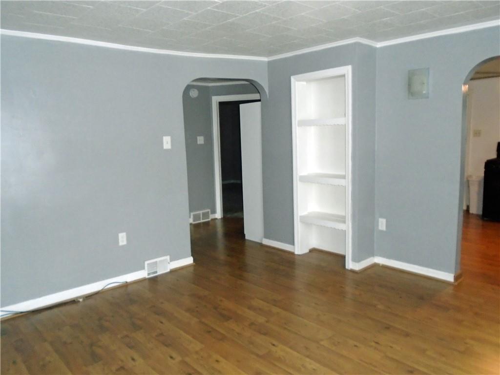 1001 7th Avenue Conway, PA 15027 - Photo 10 of 36 a view of an empty room with wooden floor and a window