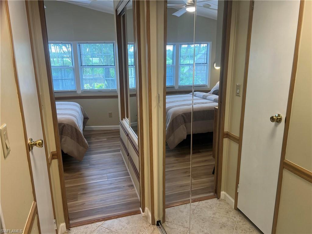 159 Cheetah Drive, Unit 159 Naples, FL 34114 - Photo 11 of 31 a view of a hallway with wooden floor and windows