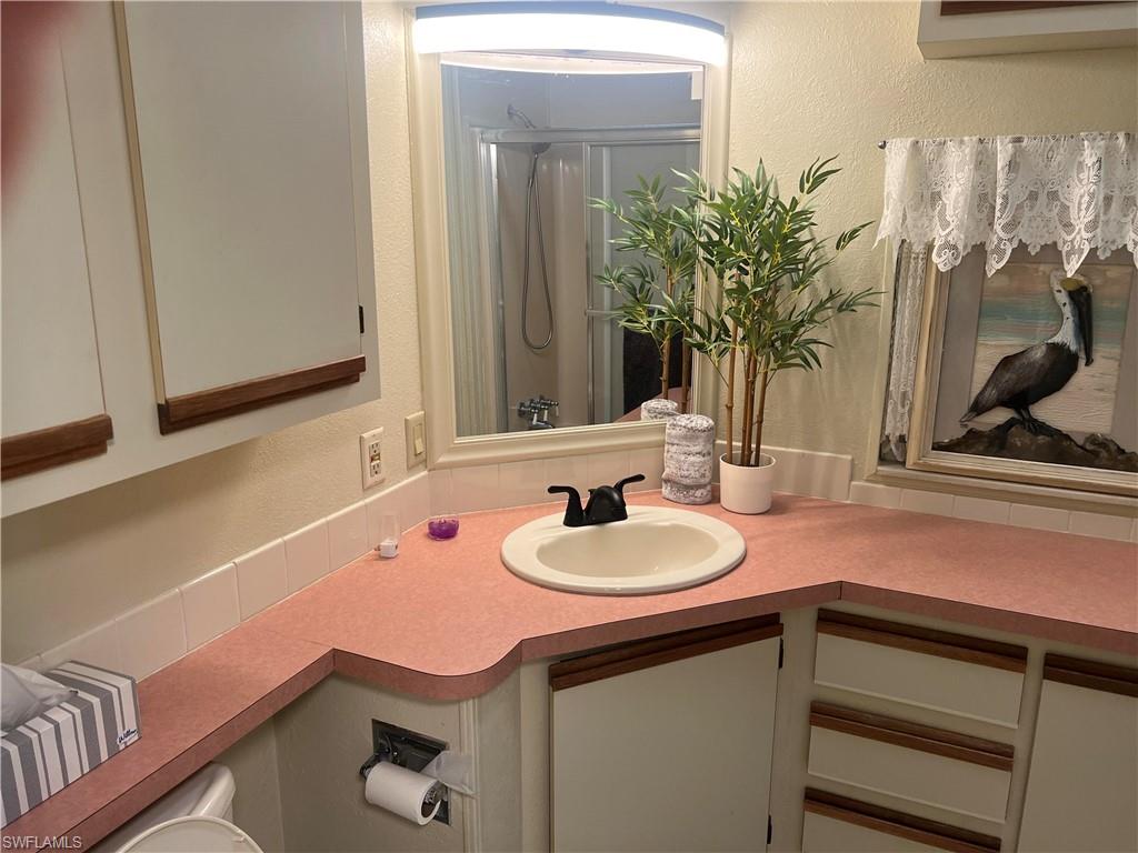 159 Cheetah Drive, Unit 159 Naples, FL 34114 - Photo 13 of 31 a bathroom with a sink and a mirror