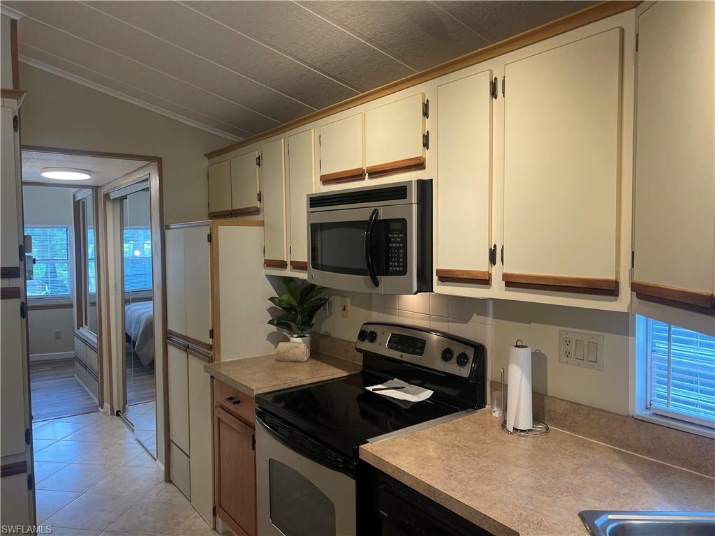 159 Cheetah Drive, Unit 159 Naples, FL 34114 - Photo 16 of 31 a kitchen with stainless steel appliances a stove and a refrigerator