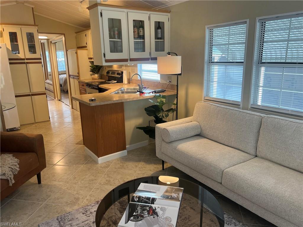 159 Cheetah Drive, Unit 159 Naples, FL 34114 - Photo 17 of 31 a living room with furniture a window and wooden floor